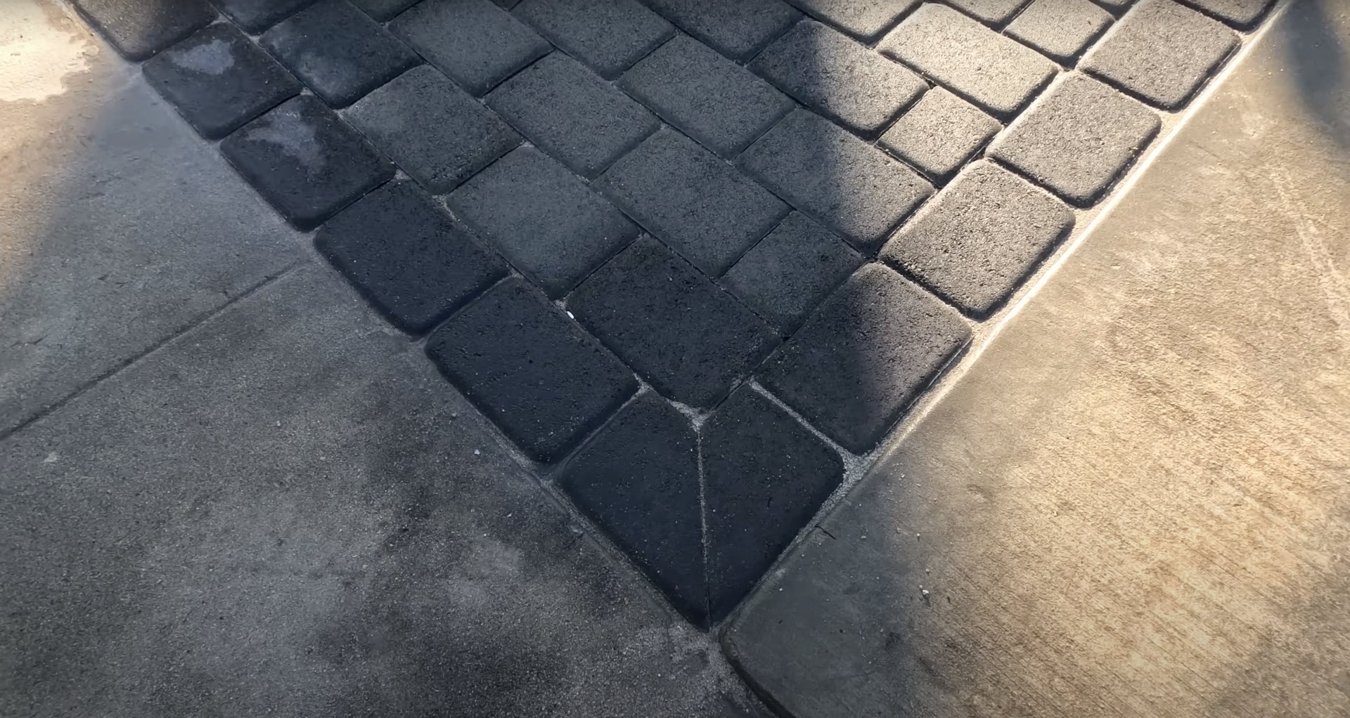 Decorative concrete paver driveway with herringbone pattern design Multi-colored concrete pavers arranged in herringbone pattern for driveway installation in Waterbury CT