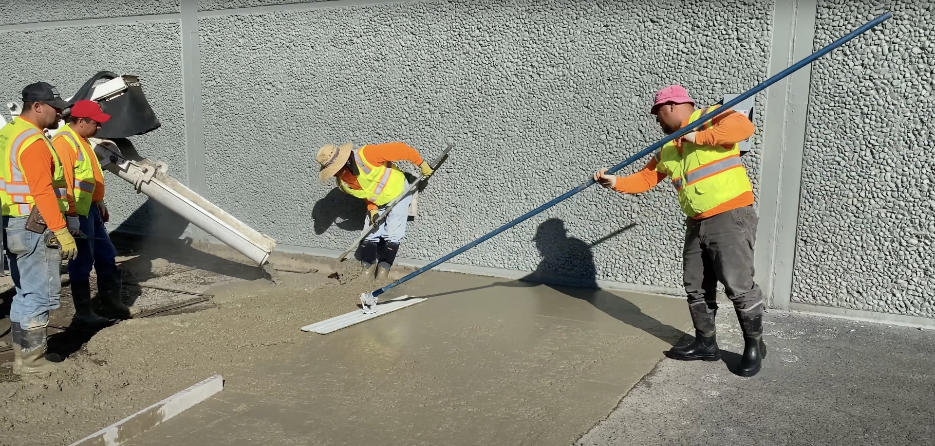Commercial concrete slab installation with professional finishing equipment Commercial concrete crew pouring and finishing concrete slab with professional equipment in Waterbury Connecticut