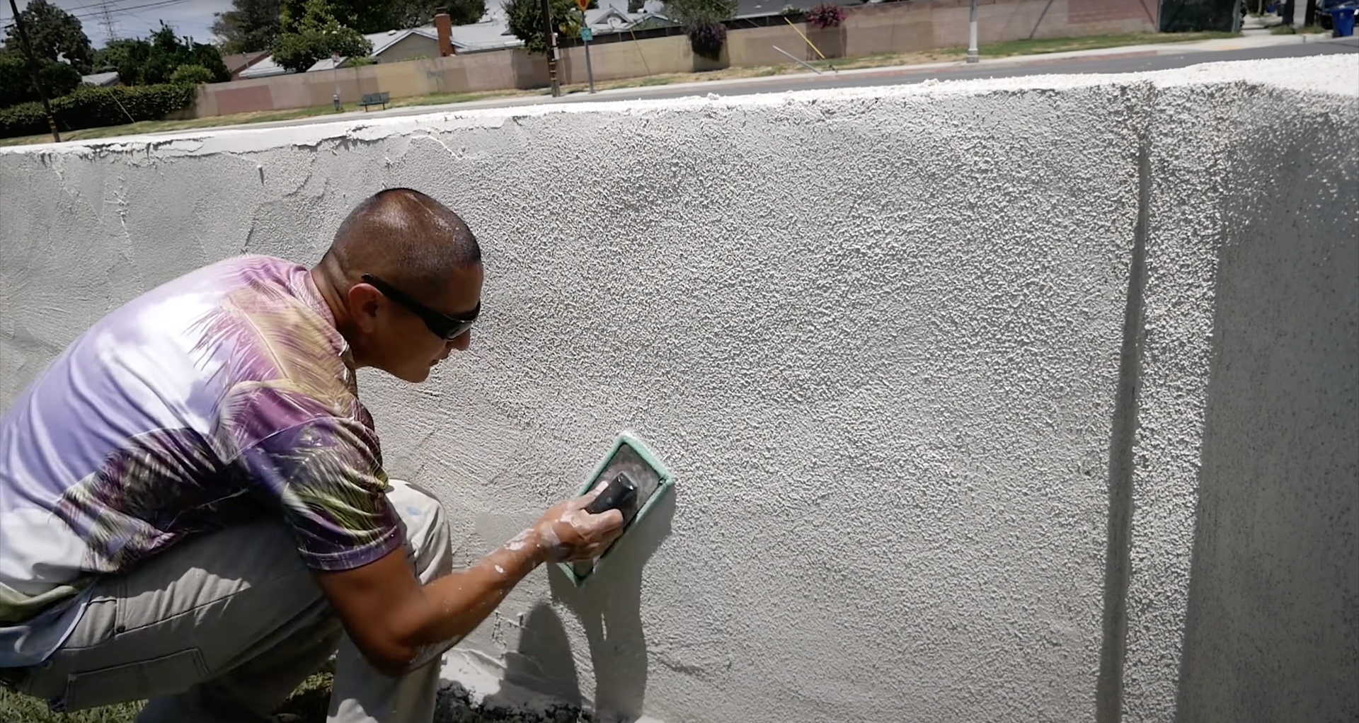 Expert concrete finishing and troweling techniques for smooth surfaces Professional concrete finisher smoothing concrete surface with trowel during installation in Waterbury Connecticut